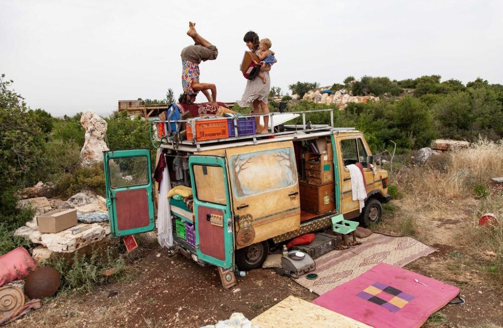 After spending several months travelling the country, the family arrives at Adama – a village in the Galilee that is home to a handful of families. They decide to park their caravan there.
Amnon, Tamar, and Malmalu Barri messing about on the rooftop of their home.  Galille ,Israel