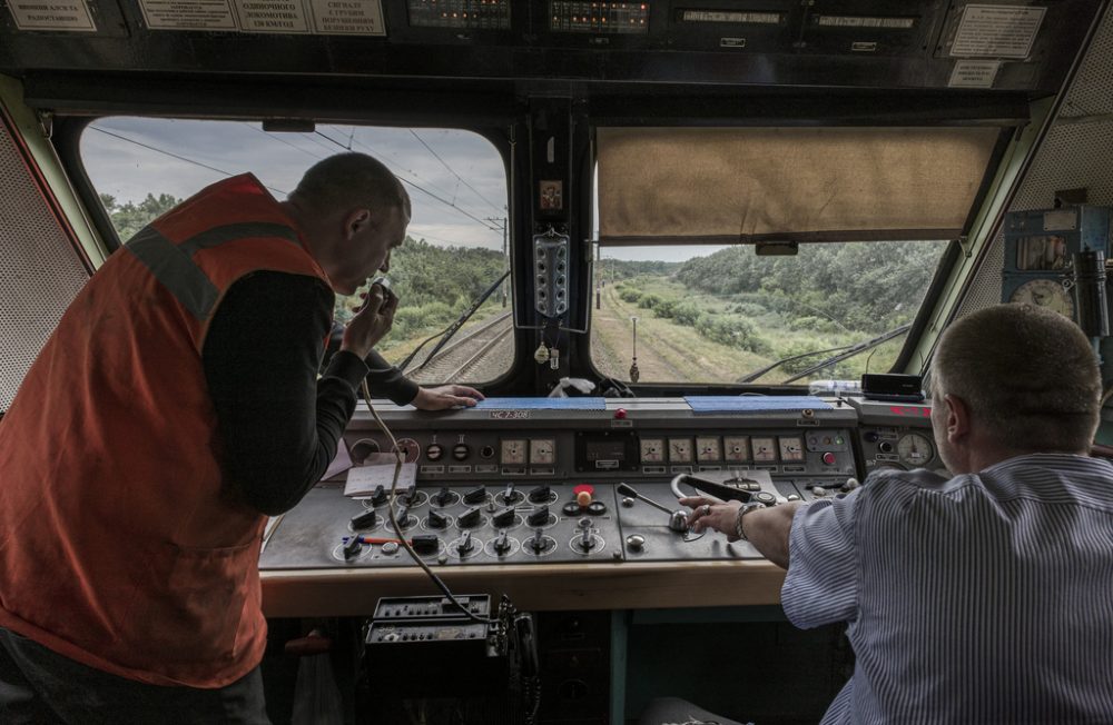 Location: On the evacuation train from Pokrovsk (Donbas) to Lviv, Ukraine
Caption Long: Train drivers Dmitrii Prishedko (43) and Victor Bondar (40) run the evacuation train from Pokrovsk to Lviv. Dmitrii has been working as a train driver since 1998. Donbas has again seen an influx of refugees due to advances of Russian forces. Pokrovsk has been struck by Russian shells and missiles multiple times in the preceding weeks. In this image, the train has just departed Pokrovsk, and is on its way to Dnipro for its first stop.