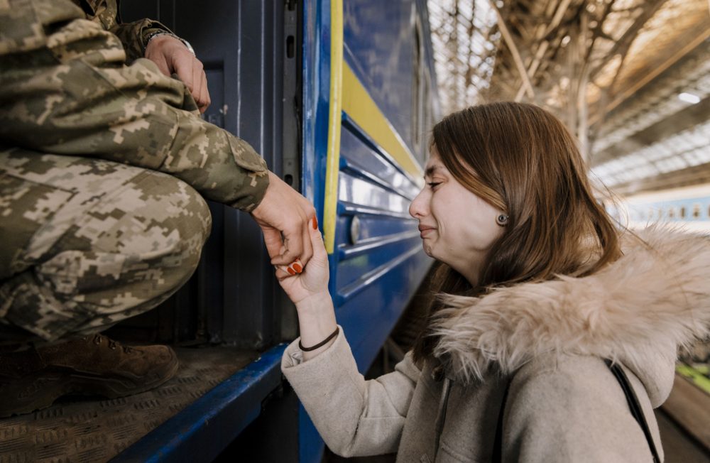LVIV, UKRAINE - 15TH OF MARCH, 2022: 
Soldier Volodimir (20, l) and his girlfriend Tanya (21) while saying goodbye at the trainstation in Lviv, Ukraine on March 15th 2022. He departs to Kramatorsk, to fight in the war that started after Russia invading Ukraine on the 24th of February 2022. CREDIT: Ilvy Njiokiktjien